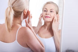 Older woman looking at herself in the mirror