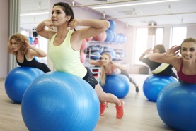 Group of women using exercise balls at the gym