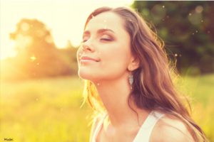 Woman smiling in the sun outdoors