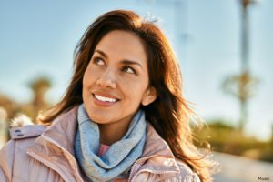 Woman outdoors in a winter jacket smiling
