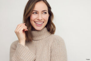 Woman in a beige sweater smiling