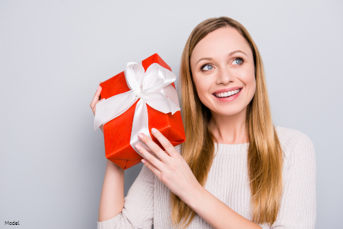 Woman smiling, holding present